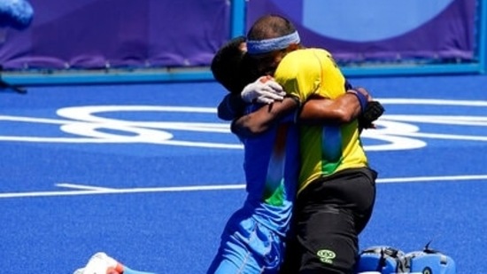 India's Surender Kumar, top left, and India goalkeeper Sreejesh Parattu Raveendran, top right, celebrate while Germany's Lukas Windfeder, bottom, reacts after India won their men's field hockey bronze medal match 5-4 at the 2020 Summer Olympics, Thursday, Aug. 5, 2021, in Tokyo, Japan. (AP Photo/John Locher)(AP)