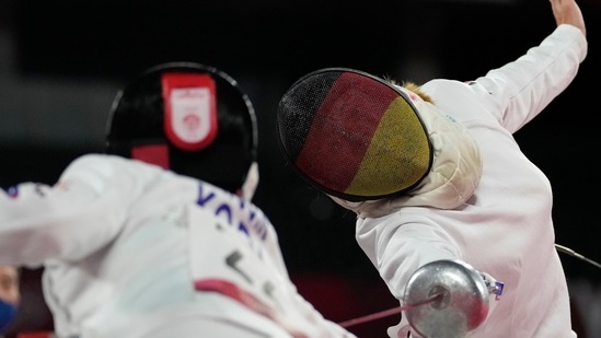 Annika Schleu of Germany, right, and Kim Sunwoo of South Korea compete in the fencing portion of the women's modern pentathlon at the 2020 Summer Olympics, Thursday, Aug. 5, 2021, in Tokyo, Japan. (AP Photo/Andrew Medichini)(AP)