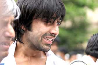 Bollywood actor Ashish Chowdhary (R) grieves after receiving news of his sister's death outside the Trident Hotel in Mumbai on November 28, 2008)