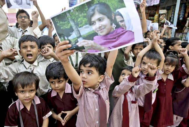 Primary students in Pakistan hold up posters in support of Malala Yousufzai. AP Primary students in Pakistan hold up posters in support of Malala Yousufzai. AP