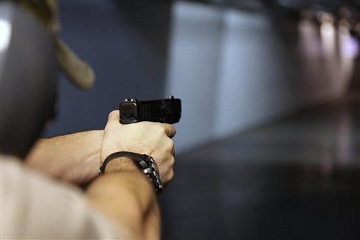 A man fires a hand gun at Sandy Springs Gun Club and Range, in Sandy Springs. In Connecticut and Colorado, scenes of the most deadly US mass shootings in 2012, people were less enthusiastic about buying new guns at the end of the year than in most other states, according to an Associated Press analysis of new FBI data. AP Photo/Robert Ray A man fires a hand gun at Sandy Springs Gun Club and Range, in Sandy Springs. In Connecticut and Colorado, scenes of the most deadly US mass shootings in 2012, people were less enthusiastic about buying new guns at the end of the year than in most other states, according to an Associated Press analysis of new FBI data. AP Photo/Robert Ray
