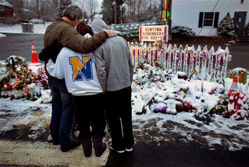 Members of the Rutter family of Sandy Hook, Connecticut, embrace early Christmas morning as they stand near memorials by the Sandy Hook firehouse in Newtown on Christmas Day. People continue to visit memorials after gunman Adam Lanza walked into Sandy Hook Elementary School and opened fire, killing 26, including 20 children, before killing himself. AP Photo/Craig Ruttle Members of the Rutter family of Sandy Hook, Connecticut, embrace early Christmas morning as they stand near memorials by the Sandy Hook firehouse in Newtown on Christmas Day. People continue to visit memorials after gunman Adam Lanza walked into Sandy Hook Elementary School and opened fire, killing 26, including 20 children, before killing himself. AP Photo/Craig Ruttle