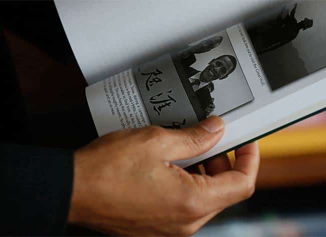 Mark Obama Ndesanjo shows the picture posing with his half-brother U.S. President Barack Obama in his self-published book "Cultures: My Odyssey of Self-Discovery" during an interview in Hong Kong. Photo: AP/Kin Cheung Mark Obama Ndesanjo shows the picture posing with his half-brother U.S. President Barack Obama in his self-published book "Cultures: My Odyssey of Self-Discovery" during an interview in Hong Kong. Photo: AP/Kin Cheung