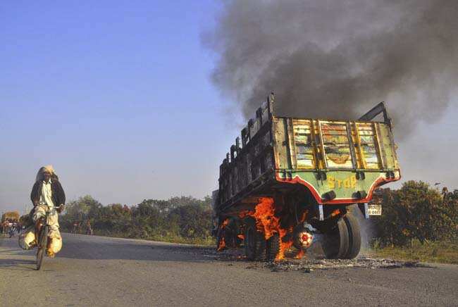 A Bangladeshi man rides past a truck set on fire by activists of Islamic party Jamaat-e-Islami during a strike in Rajshahi, Bangladesh protesting the death sentence of Delwar Hossain Sayedee. AP A Bangladeshi man rides past a truck set on fire by activists of Islamic party Jamaat-e-Islami during a strike in Rajshahi, Bangladesh protesting the death sentence of Delwar Hossain Sayedee. AP