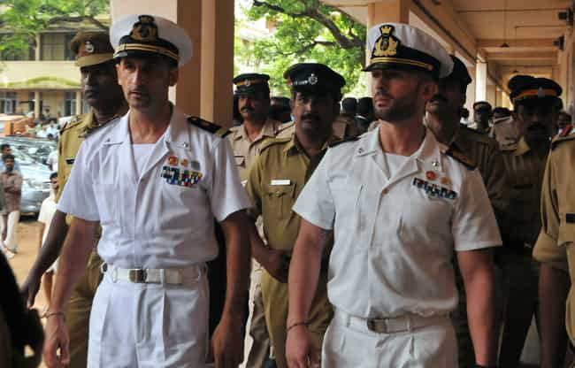 In this file photograph, Italian marines Latore Massimiliano (L) and Salvatore Girone (R) are escorted by police outside a court in Kollam. AFP photo
</div) In this file photograph, Italian marines Latore Massimiliano (L) and Salvatore Girone (R) are escorted by police outside a court in Kollam. AFP photo
</div)