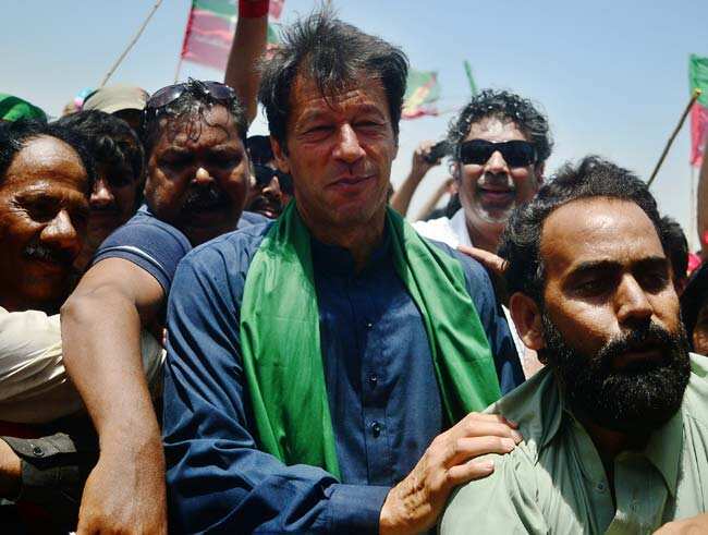 Cricket legend and chairman of Pakistan Tehreek-e-Insaaf (PTI) Imran Khan is surrounded by his supporters during a campaign rally in Karachi. AF) Cricket legend and chairman of Pakistan Tehreek-e-Insaaf (PTI) Imran Khan is surrounded by his supporters during a campaign rally in Karachi. AF)