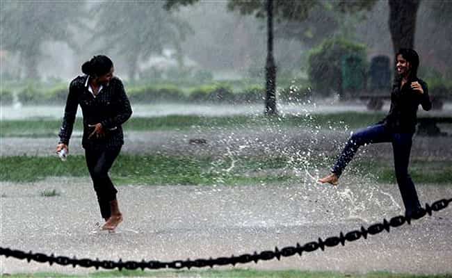 Young girls play at a lawn during heavy shower in New Delhi. PTI Photo Young girls play at a lawn during heavy shower in New Delhi. PTI Photo