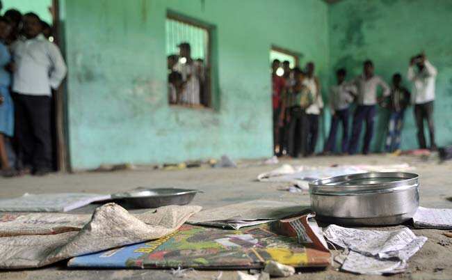 The scattered belongings of children who consumed a free mid day meal, are seen in Dharma Sati village in the Saran district of Bihar. (AFP photo)
</div) The scattered belongings of children who consumed a free mid day meal, are seen in Dharma Sati village in the Saran district of Bihar. (AFP photo)
</div)