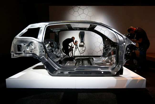 Cameramen work around the carbon fibre chassis for BMW's new i3 electric before it was unveiled in London. Reuters photo BMW pulls wraps off its all-electric car i3, eyes Indian market