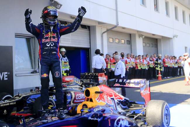 Red Bull driver Sebastian Vettel of Germany celebrates on his car