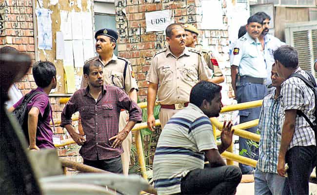 Students and police on the JNU campus on Wednesday after an undergraduate student attacked a classmate with an axe and then killed self. (HT Photo)
</div) Students and police on the JNU campus on Wednesday after an undergraduate student attacked a classmate with an axe and then killed self. (HT Photo)
</div)