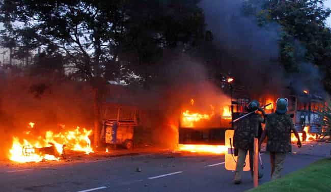 Policemen walk near burning vehicles set on fire during Telangana march in Hyderabad, Sept 30. PTI Photo Policemen walk near burning vehicles set on fire during Telangana march in Hyderabad, Sept 30. PTI Photo