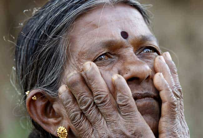 In this Dec. 5, 2012 photo, Gangarangamma, 65, gestures as she speaks to The Associated Press near the land, she and her husband farmed for decades which the records show is registered to the government, a sign the land remained in dispute, in village Karadigere Kaval, 85 kilometers (53 miles) from Bangalore, India. For years, Karnataka's land records were a quagmire of disputed, forged documents maintained by thousands of tyrannical bureaucrats who demanded bribes to do their jobs. In 2002, there were hopes that this was about to change. Photo: AP/Aijaz Rah) In this Dec. 5, 2012 photo, Gangarangamma, 65, gestures as she speaks to The Associated Press near the land, she and her husband farmed for decades which the records show is registered to the government, a sign the land remained in dispute, in village Karadigere Kaval, 85 kilometers (53 miles) from Bangalore, India. For years, Karnataka's land records were a quagmire of disputed, forged documents maintained by thousands of tyrannical bureaucrats who demanded bribes to do their jobs. In 2002, there were hopes that this was about to change. Photo: AP/Aijaz Rah)
