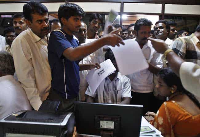 In this Dec. 10, 2012 photo, people crowd inside the government registrar's office to get their land registered, in Hoskote 30 kilometers (19 miles) from Bangalore in the southern Indian state of Karnataka. For years, Karnataka's land records were a quagmire of disputed, forged documents maintained by thousands of tyrannical bureaucrats who demanded bribes to do their jobs. In 2002, there were hopes that this was about to change. Photo: AP/Aijaz Rah) In this Dec. 10, 2012 photo, people crowd inside the government registrar's office to get their land registered, in Hoskote 30 kilometers (19 miles) from Bangalore in the southern Indian state of Karnataka. For years, Karnataka's land records were a quagmire of disputed, forged documents maintained by thousands of tyrannical bureaucrats who demanded bribes to do their jobs. In 2002, there were hopes that this was about to change. Photo: AP/Aijaz Rah)