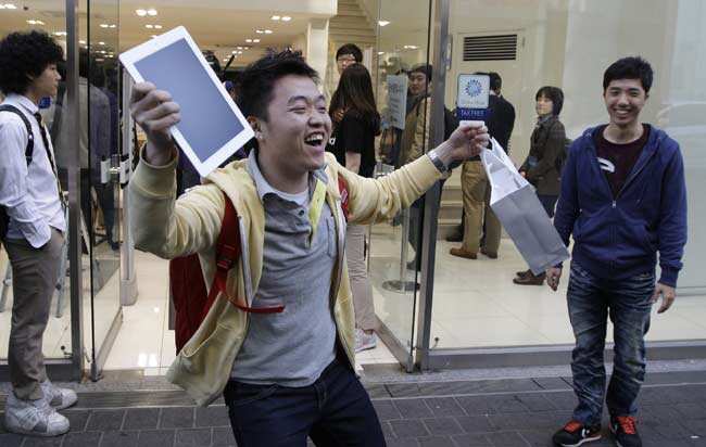 FILE - In this Friday, April 20, 2012, file photo, Baek Sung-min, 23, reacts after purchasing a new iPad at an Apple store in Seoul, South Korea. In Google's 12th annual roundup of global trending searches, the iPad 3 was ranked fourth. Photo: AP/Lee Jin-man