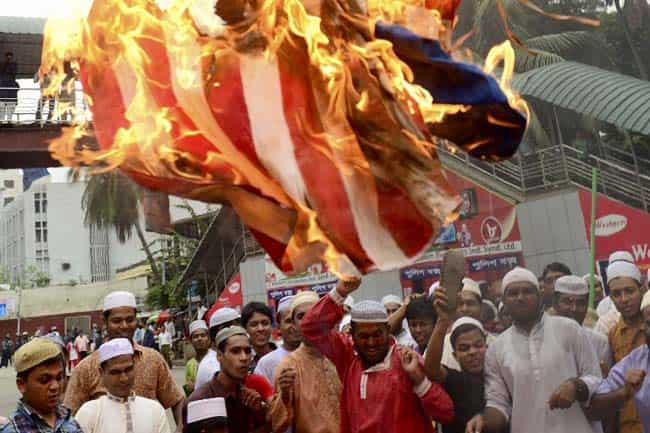 Islamic party activists set fire to a US flag during a protest against an internet film mocking Islam in Dhaka. AFP/Munir uz Zaman Islamic party activists set fire to a US flag during a protest against an internet film mocking Islam in Dhaka. AFP/Munir uz Zaman