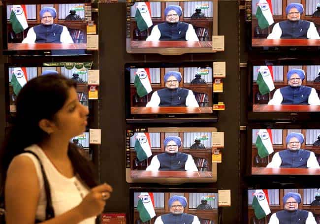 A girl watching TV during Prime Minister Manmohan Singh address the nation about the recent decisions on economic reforms, at a showroom in Mumbai. PTI Photo A girl watching TV during Prime Minister Manmohan Singh address the nation about the recent decisions on economic reforms, at a showroom in Mumbai. PTI Photo