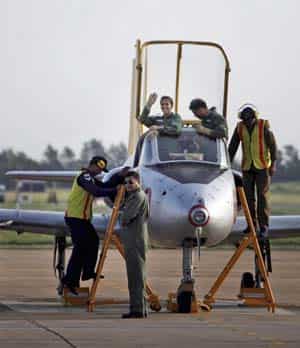 Badminton player Saina Nehwal waves as she enters the cockpit of an IAF aircraft. (AP Photo) 
</div)