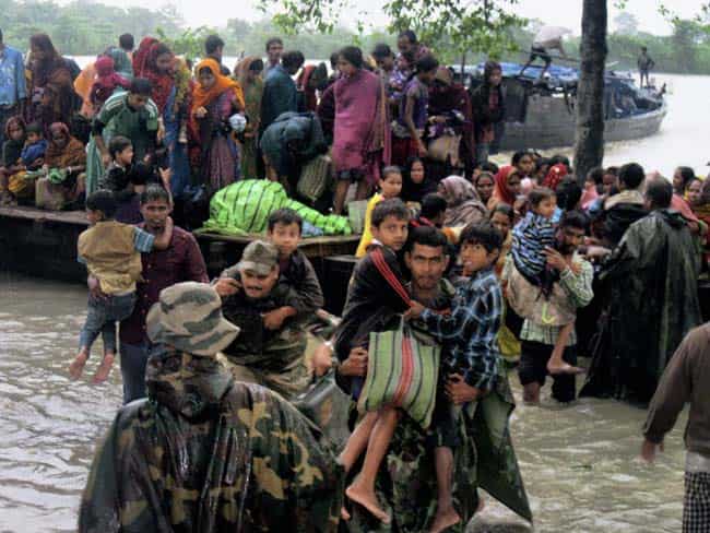 Army personnel shift flood-affected people to safer places at Dhola in Tinsukia District of Assam.