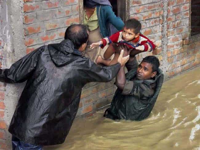 Army personnel shift flood-affected people to safer places at Dhola in Tinsukia District of Assam. Army personnel shift flood-affected people to safer places at Dhola in Tinsukia District of Assam.