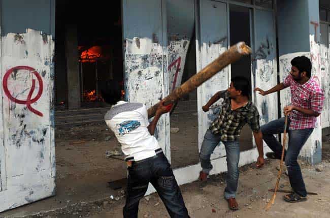 Demonstrators attack a cinema during a protest against an anti-Islam film in Karachi. AFP photo