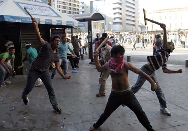 Muslim immigrants living in Athens throw objects at riot police during a protest on Sunday against a film produced in the US that they say insults the Prophet Muhammad in Athens. The protesters tried to march to the U.S. Embassy, but riot police blocked all exits from the square and used tear gas to disperse the protesters. It is the first such protest against the film by Muslims in Greece. (AP Photo/Kostas Tsironis)
</div) Muslim immigrants living in Athens throw objects at riot police during a protest on Sunday against a film produced in the US that they say insults the Prophet Muhammad in Athens. The protesters tried to march to the U.S. Embassy, but riot police blocked all exits from the square and used tear gas to disperse the protesters. It is the first such protest against the film by Muslims in Greece. (AP Photo/Kostas Tsironis)
</div)