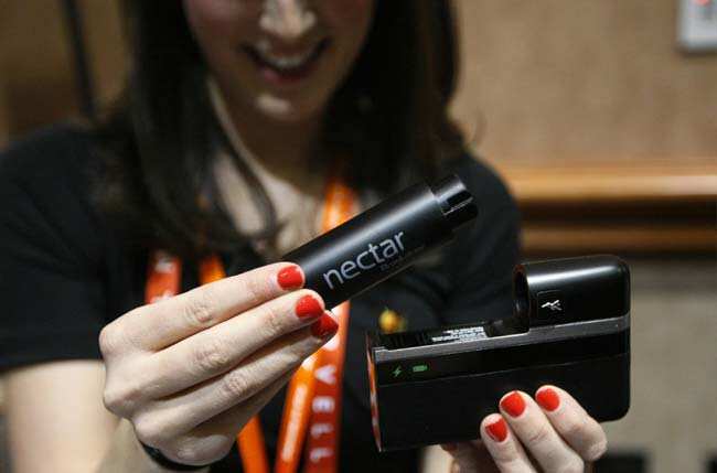A woman demonstrates the Nectar mobile power source at the opening press event of the Consumer Electronics Show (CES) in Las Vegas January 6, 2013. The device announced on Sunday at CES, will charge and power a mobile device for up to two weeks. CES, the world's largest technology conference, kicks off on Monday. REUTERS/Rick Wilkin) A woman demonstrates the Nectar mobile power source at the opening press event of the Consumer Electronics Show (CES) in Las Vegas January 6, 2013. The device announced on Sunday at CES, will charge and power a mobile device for up to two weeks. CES, the world's largest technology conference, kicks off on Monday. REUTERS/Rick Wilkin)