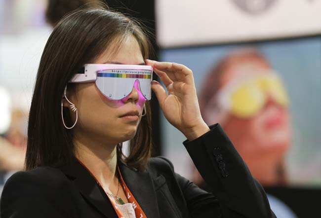 An industry affiliate tries a pair of PSiO Mind Booster stress management glasses at the Consumer Electronics Show, Wednesday, Jan. 9, 2013, in Las Vegas. The glasses use precise light and sound rhythms to stimulate the brain and influence the user's state of mind. Photo: AP/Julie Jacobson An industry affiliate tries a pair of PSiO Mind Booster stress management glasses at the Consumer Electronics Show, Wednesday, Jan. 9, 2013, in Las Vegas. The glasses use precise light and sound rhythms to stimulate the brain and influence the user's state of mind. Photo: AP/Julie Jacobson