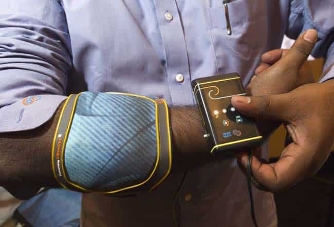 Kranthi Vistakula models a Climaware Contrast Relief System elbow wrap by Dharma Innovations, during the Consumer Electronics Show (CES) in Las Vegas January 9, 2013. The system uses technology developed at Massachusetts Institute of Technology and can cool wraps to 38 Fahrenheit (3.3 Celsius) or heat them to 140 Fahrenheit (60 Celsius) in seconds, Vistakula said. Reuters/Steve Marcu) Kranthi Vistakula models a Climaware Contrast Relief System elbow wrap by Dharma Innovations, during the Consumer Electronics Show (CES) in Las Vegas January 9, 2013. The system uses technology developed at Massachusetts Institute of Technology and can cool wraps to 38 Fahrenheit (3.3 Celsius) or heat them to 140 Fahrenheit (60 Celsius) in seconds, Vistakula said. Reuters/Steve Marcu)