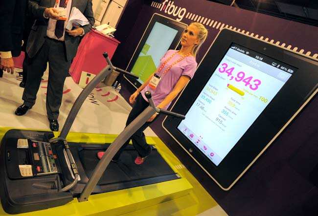Woman uses The Fitbug pedometer ,system uplinks to a web site to track your walking steps, distance, diet and fitness activities, at the Las Vegas Convention Center on January 9, 2013 in Las Vegas, Nevada. CES, the world's largest annual consumer technology trade show, runs from January 8-11 and is expected to feature 3,100 exhibitors showing off their latest products and services to about 150,000 attendees.Photo: AFP / Joe Klamar Woman uses The Fitbug pedometer ,system uplinks to a web site to track your walking steps, distance, diet and fitness activities, at the Las Vegas Convention Center on January 9, 2013 in Las Vegas, Nevada. CES, the world's largest annual consumer technology trade show, runs from January 8-11 and is expected to feature 3,100 exhibitors showing off their latest products and services to about 150,000 attendees.Photo: AFP / Joe Klamar