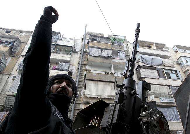 A member of the Free Syrian Army gestures while on patrol in Aleppo's Bustan Al Qaser district January 2, 2013. Photo: Reuters/UNI A member of the Free Syrian Army gestures while on patrol in Aleppo's Bustan Al Qaser district January 2, 2013. Photo: Reuters/UNI