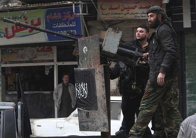 Members of the Free Syrian Army stand behind a machine gun turret as they patrol on the back of a truck in Aleppo's Bustan Al Qaser district January 2, 2013. Reuters/Muzaffar Salman Members of the Free Syrian Army stand behind a machine gun turret as they patrol on the back of a truck in Aleppo's Bustan Al Qaser district January 2, 2013. Reuters/Muzaffar Salman