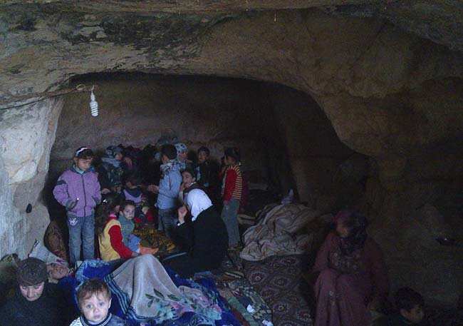 Residents take shelter in a cave near Hama December 24, 2012. Picture taken December 24, 2012. Reuters/Samer Al-Hamwi/Shaam News Network/Handout Residents take shelter in a cave near Hama December 24, 2012. Picture taken December 24, 2012. Reuters/Samer Al-Hamwi/Shaam News Network/Handout