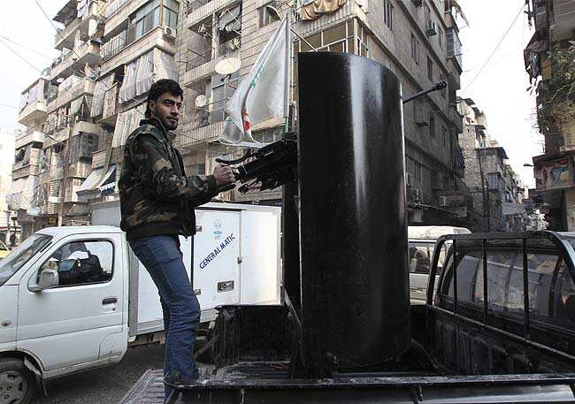 A member of the Free Syrian Army stands atop a truck while on patrol in Aleppo's Bustan Al Qaser district January 2, 2013. Reuters/Muzaffar Salman A member of the Free Syrian Army stands atop a truck while on patrol in Aleppo's Bustan Al Qaser district January 2, 2013. Reuters/Muzaffar Salman