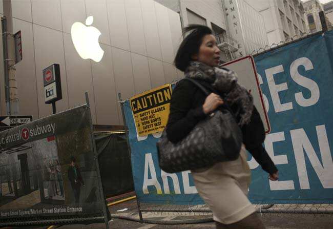 A woman walks past an Apple logo at the company's flagship retail store near signs for the central subway project in San Francisco, California January 23, 2013. Photo: Reuters/Robert Galbraith A woman walks past an Apple logo at the company's flagship retail store near signs for the central subway project in San Francisco, California January 23, 2013. Photo: Reuters/Robert Galbraith