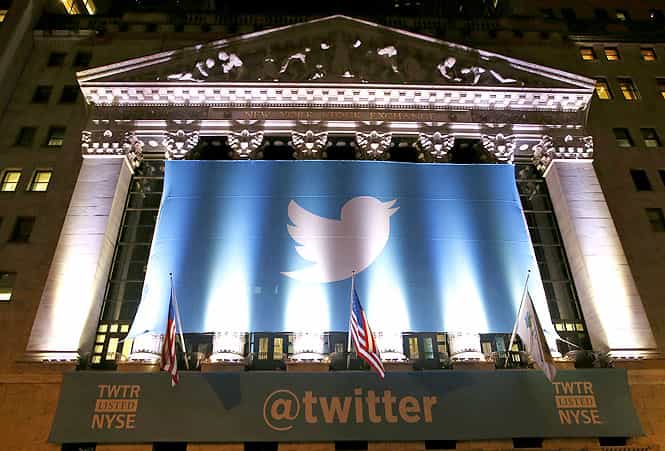 A banner adorns the facade of the New York Stock Exchange in advance of Twitter's initial public offering in New York. (AP photo)</em) A banner adorns the facade of the New York Stock Exchange in advance of Twitter's initial public offering in New York. (AP photo)</em)