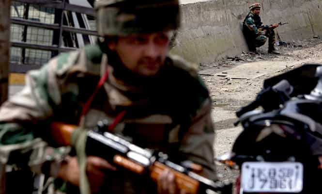File photo: Indian army soldiers take position during a shooting near a military convoy on the outskirts of Srinagar. (AP Photo)