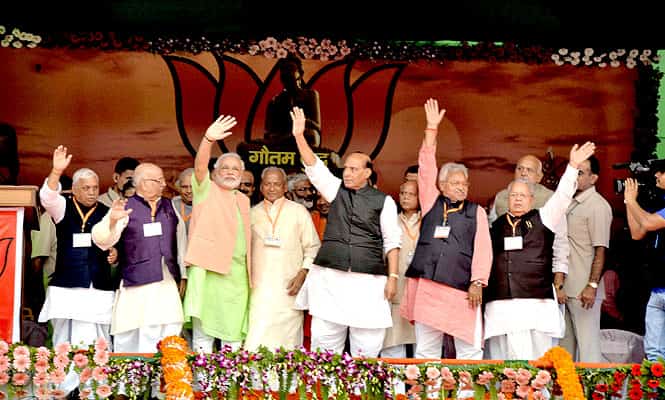 Gujarat CM and BJP PM candidate Narendra Modi waves along with party president Rajnath Singh and other party leaders during a rally in Bahraich, UP. (PTI Photo) Gujarat CM and BJP PM candidate Narendra Modi waves along with party president Rajnath Singh and other party leaders during a rally in Bahraich, UP. (PTI Photo)