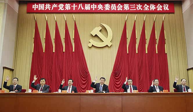 In this Nov. 12, 2013 file photo released by China's Xinhua news agency, Chinese President Xi Jinping, center, and other Communist Party top leaders raise their hands to vote in the third plenary session of the 18th Central Committee of the Communist Party of China, in Beijing. (AP photo) </em>
</div) In this Nov. 12, 2013 file photo released by China's Xinhua news agency, Chinese President Xi Jinping, center, and other Communist Party top leaders raise their hands to vote in the third plenary session of the 18th Central Committee of the Communist Party of China, in Beijing. (AP photo) </em>
</div)