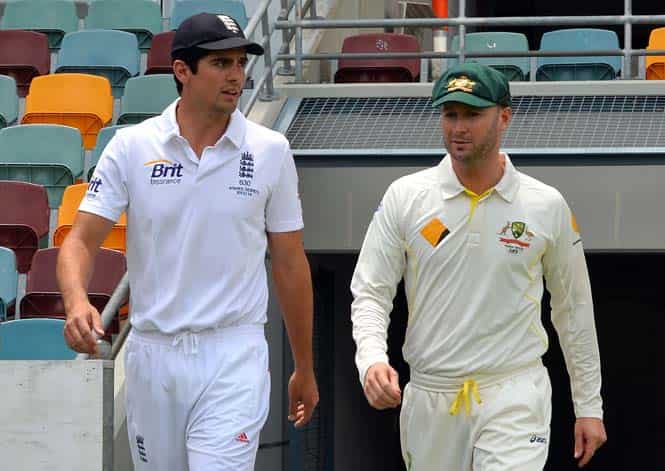 England captain Alistair Cook and Australian captain Michael Clarke walk onto the grounds following a photo call at the Gabba in Brisbane. (AFP Photo) 
</div)