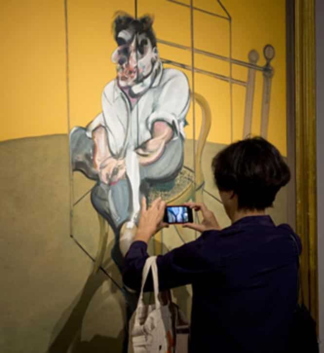 A journalist takes a photo of Francis Bacon's 'Three Studies of Lucian Freud' at Christie's in New York. (AFP Photo) A journalist takes a photo of Francis Bacon's 'Three Studies of Lucian Freud' at Christie's in New York. (AFP Photo)