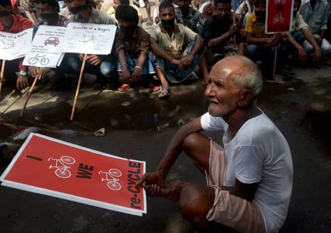 Hand-pulled rickshaw riders and cyclists sit with placards during a protest in Kolkata over a move to ban them from major roads. (AFP photo) Hand-pulled rickshaw riders and cyclists sit with placards during a protest in Kolkata over a move to ban them from major roads. (AFP photo)