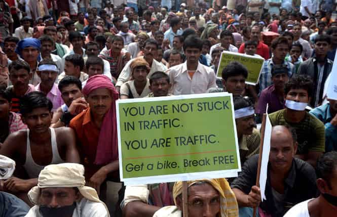 Hand-pulled rickshaw riders and cyclists sit with placards during a protest in Kolkata over a move to ban them from major roads. (AFP photo) Hand-pulled rickshaw riders and cyclists sit with placards during a protest in Kolkata over a move to ban them from major roads. (AFP photo)