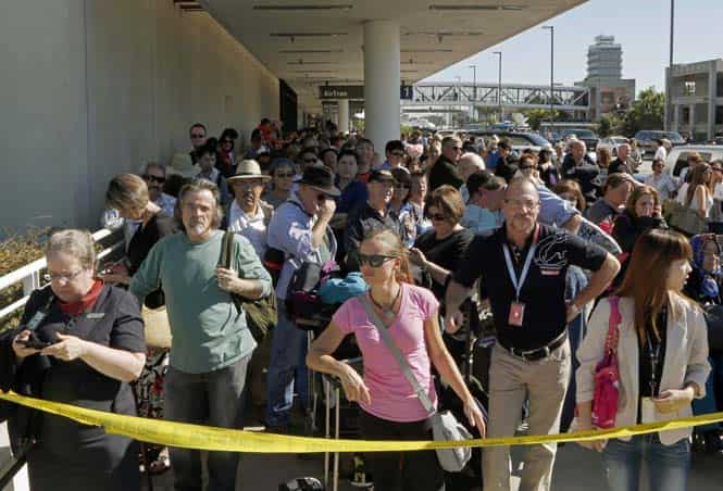 Passengers evacuated from Terminal 1 wait outside Los Angeles International Airport after shots were fired, prompting authorities to evacuate a terminal and stop flights headed for the city from taking off from other airports. (AP Photo) Passengers evacuated from Terminal 1 wait outside Los Angeles International Airport after shots were fired, prompting authorities to evacuate a terminal and stop flights headed for the city from taking off from other airports. (AP Photo)