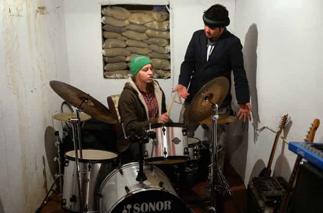 Kabul School of Rock's director, Robin (L) teaches drums to an Afghan music student at 'Kabul School of Rock' in Kabul. (AFP Photo)
</div) Kabul School of Rock's director, Robin (L) teaches drums to an Afghan music student at 'Kabul School of Rock' in Kabul. (AFP Photo)
</div)