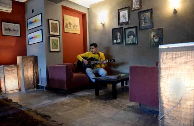 In this picture taken on October 22, 2013, Afghan music student Omar Paiman, 18, pratices the guitar at 'Kabul School of Rock' in Kabul. (AFP Photo)
</div) In this picture taken on October 22, 2013, Afghan music student Omar Paiman, 18, pratices the guitar at 'Kabul School of Rock' in Kabul. (AFP Photo)
</div)