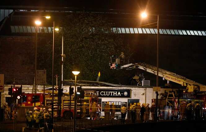 Police officers and firefighters inspect the damage of a helicopter crash, at a pub in Glasgow. AP Photo Police officers and firefighters inspect the damage of a helicopter crash, at a pub in Glasgow. AP Photo