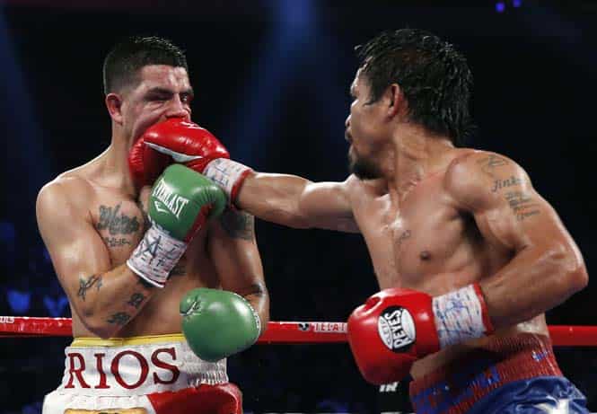 Manny Pacquiao, from the Philippines, right, lands a right to Brandon Rios of the United States during their WBO international welterweight title fight in Macau. (AP Photo)</em> 
</div)
