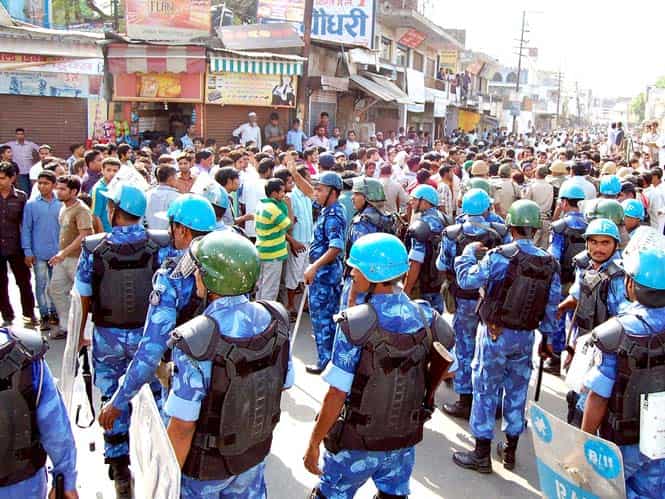 Heavy police force deployment at a crossing in Muzaffarnagar after clashes between members of two communities. (PTI photo)</em) Heavy police force deployment at a crossing in Muzaffarnagar after clashes between members of two communities. (PTI photo)</em)