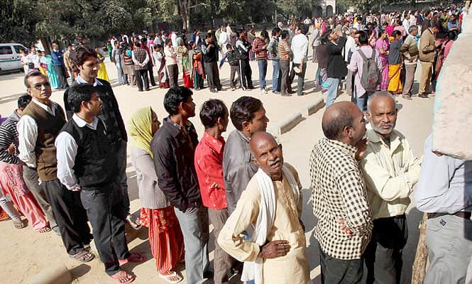 People stand in queues at a polling station to cast their votes in Chhatarpur. (PTI photo)</em) People stand in queues at a polling station to cast their votes in Chhatarpur. (PTI photo)</em)